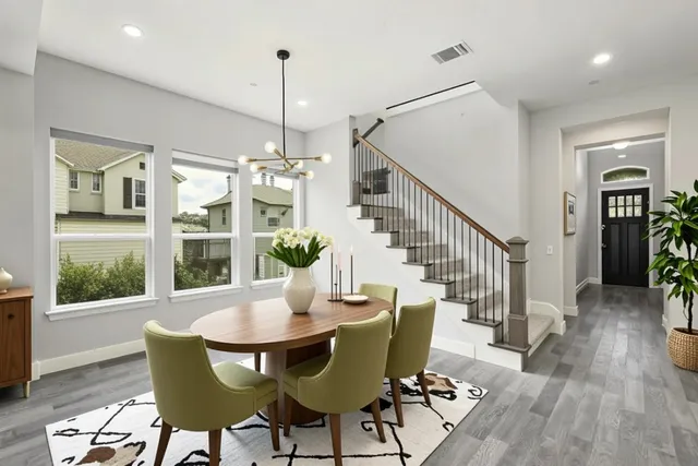 a view of a dining room with furniture window and wooden floor
