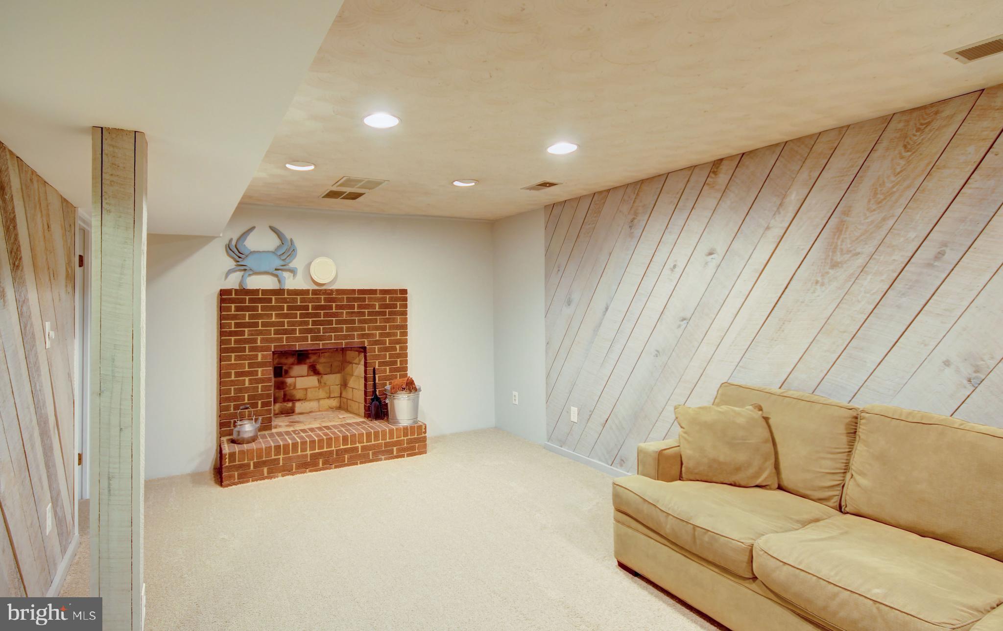 4934 Fleming Road Mount Airy, MD 21771 - Photo 14 of 42 Basement fireplace, barn wood walls