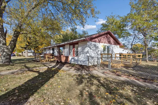 a view of a yard with wooden fence