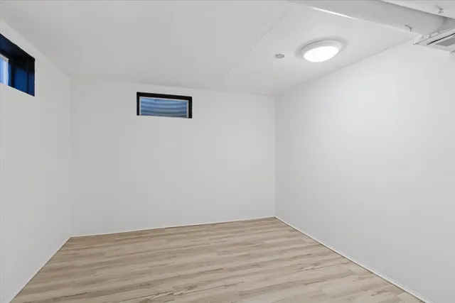 a view of a room with wooden floor