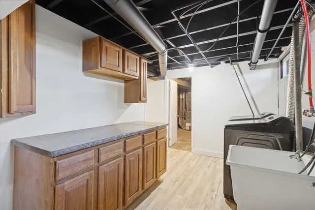 a kitchen with a refrigerator and a sink