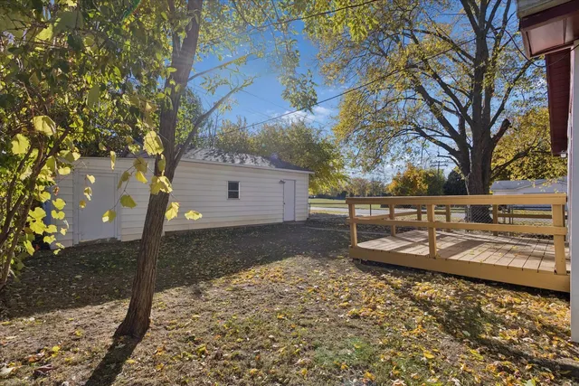 a view of a yard with wooden fence