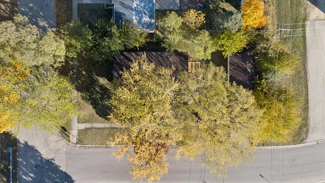 an aerial view of a house with a yard and lake view