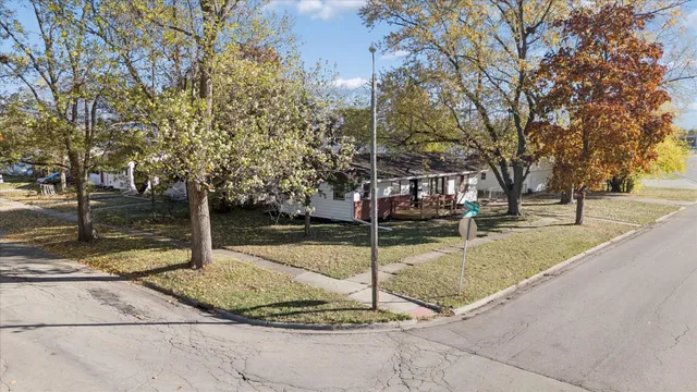 a view of a yard with plants and trees