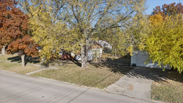 an aerial view of a house with a yard
