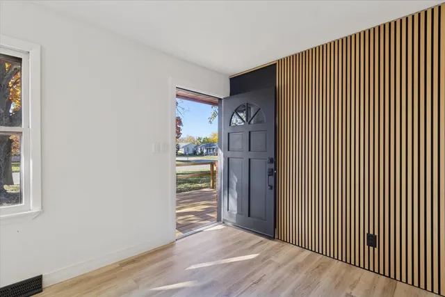 a view of an empty room with wooden floor