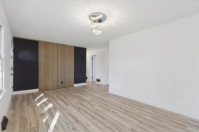 a view of a livingroom with a chandelier fan