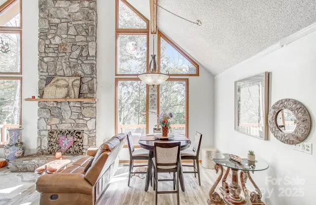 a dining room with furniture and a large window