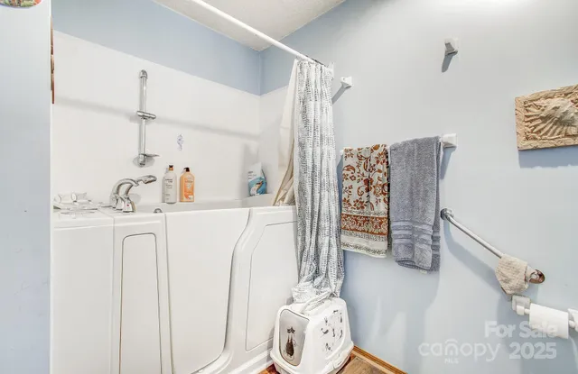a bathroom with a sink a toilet and shower curtain