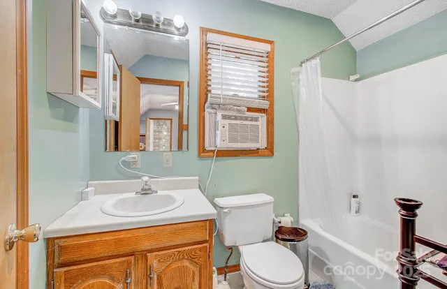 a bathroom with a sink toilet and mirror