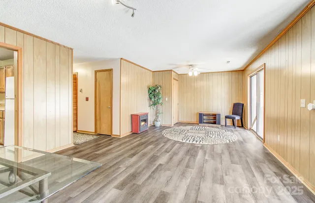 a large bedroom with a bed and a large window