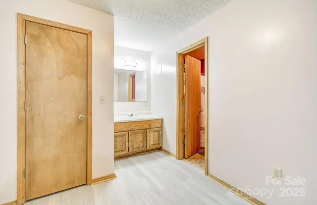 a view of bathroom with a sink and a mirror