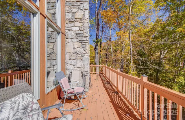a view of a balcony with wooden floor and chair