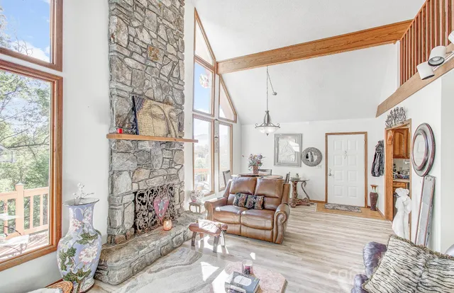a living room with fireplace furniture and a wooden floor