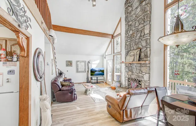 a living room with furniture a rug and a large window