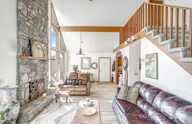 a living room with fireplace furniture and a rug