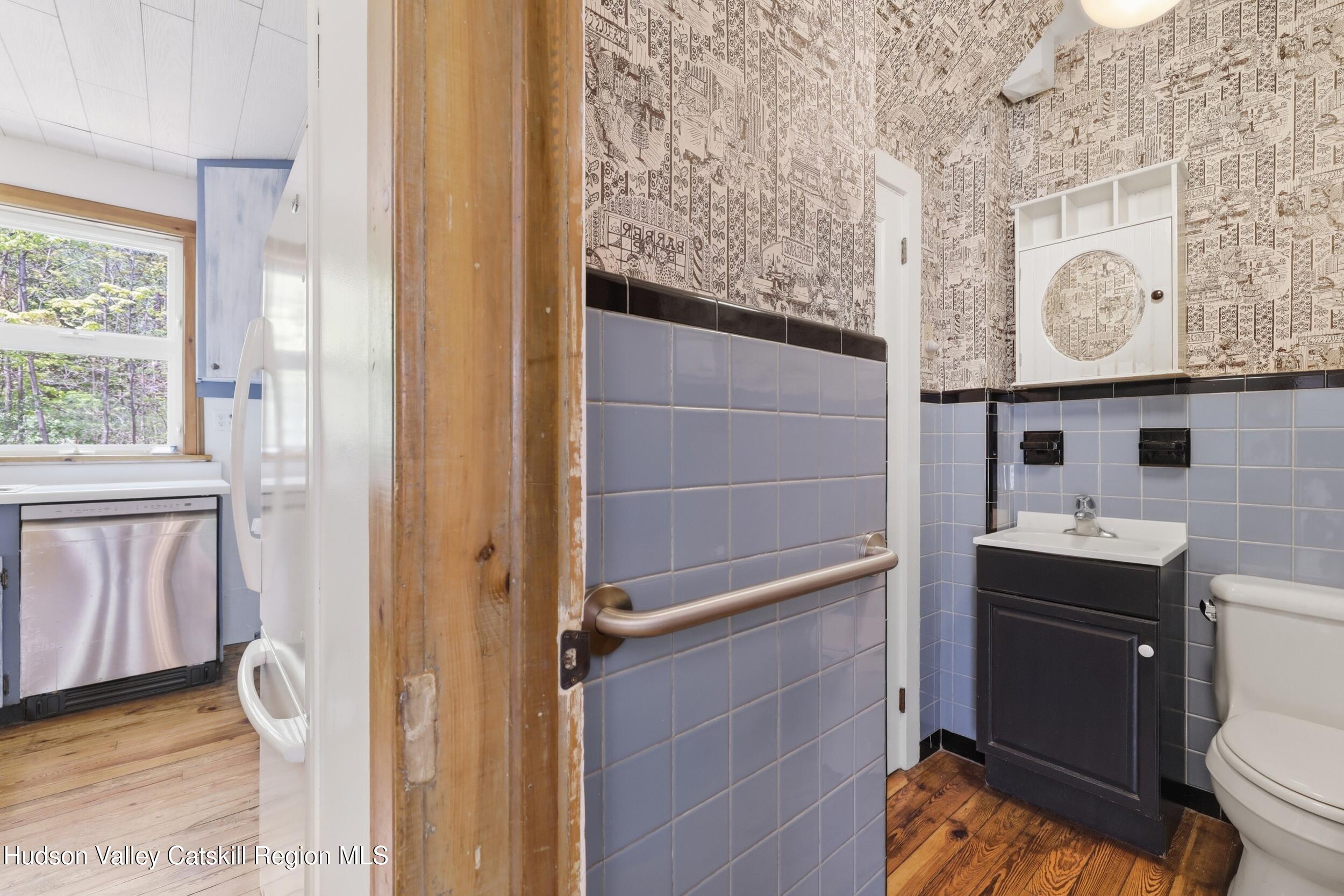 294 Kyserike Road Accord, NY 12404 - Photo 15 of 46 a bathroom with a granite countertop sink mirror vanity and toilet