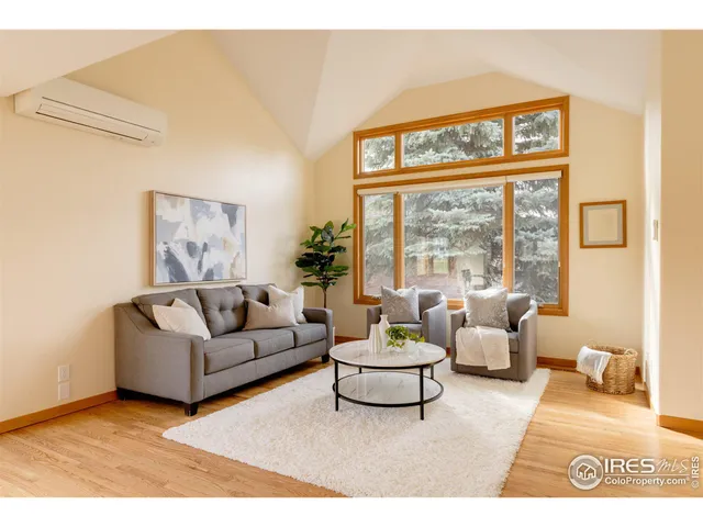 a living room with furniture a fireplace and a large window