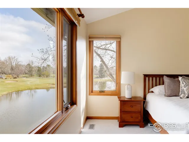a bathroom with a double vanity sink a large mirror a bathtub and shower