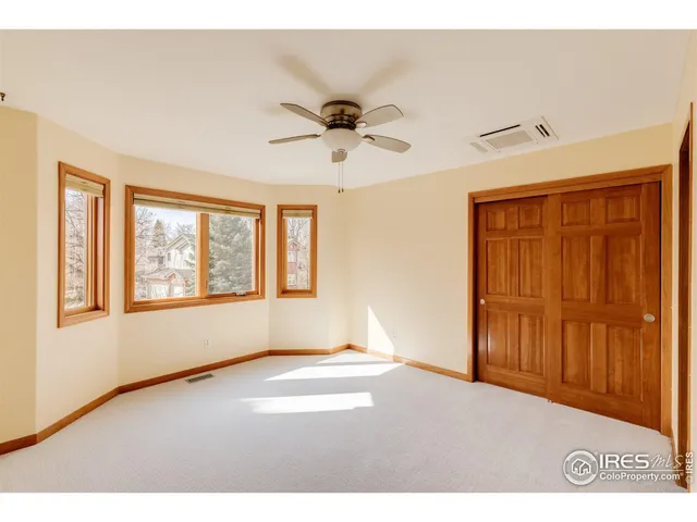a living room with furniture a rug and a floor to ceiling window