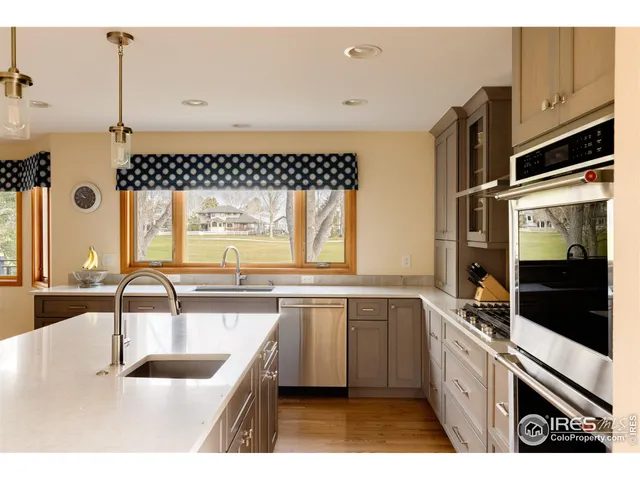 a kitchen with a stove a refrigerator and a dining table