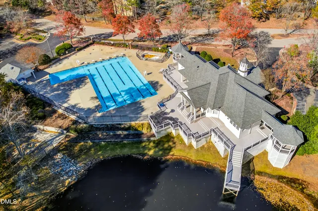an aerial view of a house with a yard and sitting area