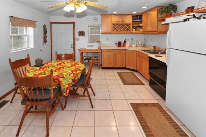 22441 Rockdale Road Cambridge Springs, PA 16403 - Photo 4 of 22 a kitchen with stainless steel appliances kitchen island granite countertop a stove a sink and a refrigerator