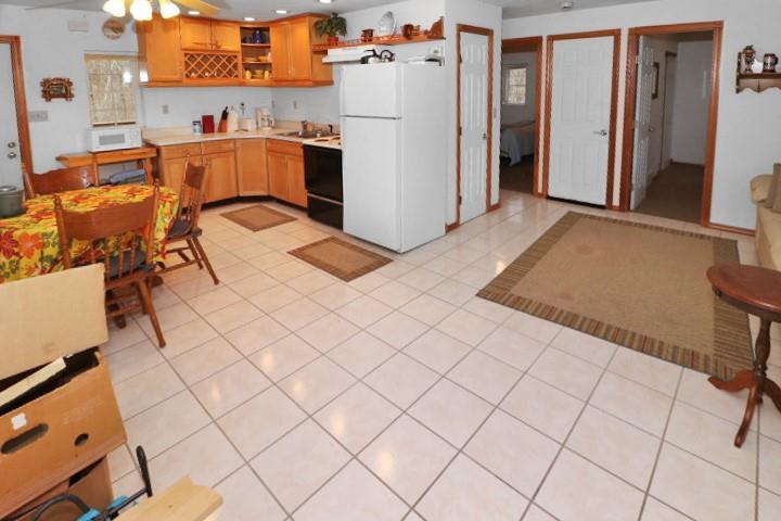 22441 Rockdale Road Cambridge Springs, PA 16403 - Photo 5 of 22 a view of a kitchen with fridge and workspace
