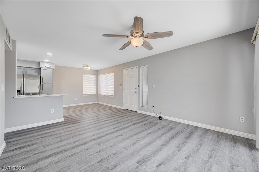 3425 East Russell Road, Unit 223 Las Vegas, NV 89120 - Photo 14 of 47 An inviting open-concept living area with wood-look flooring flows into a functional kitchen.