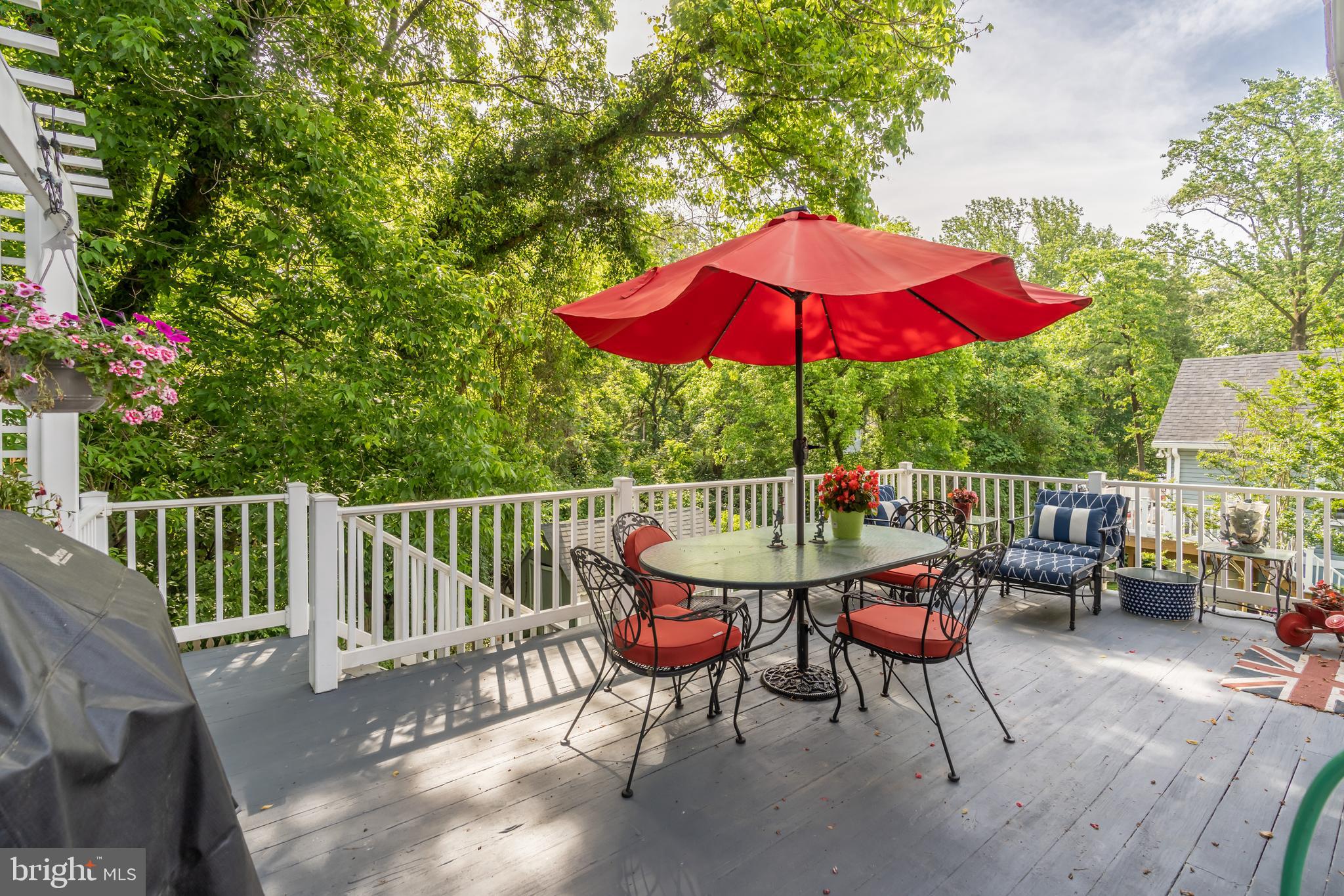 Raised deck with staircase to patio and backyard
