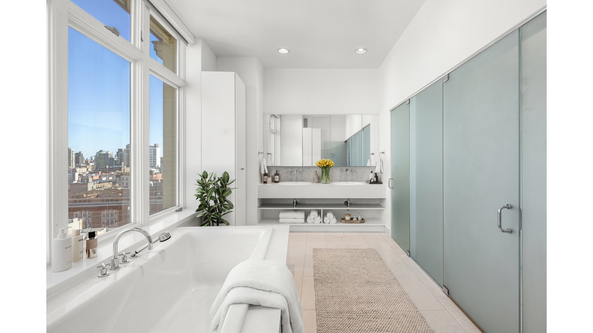 129 Lafayette Street, Unit PHA Manhattan, NY 10013 - Photo 20 of 26 a large white kitchen with a large window and stainless steel appliances