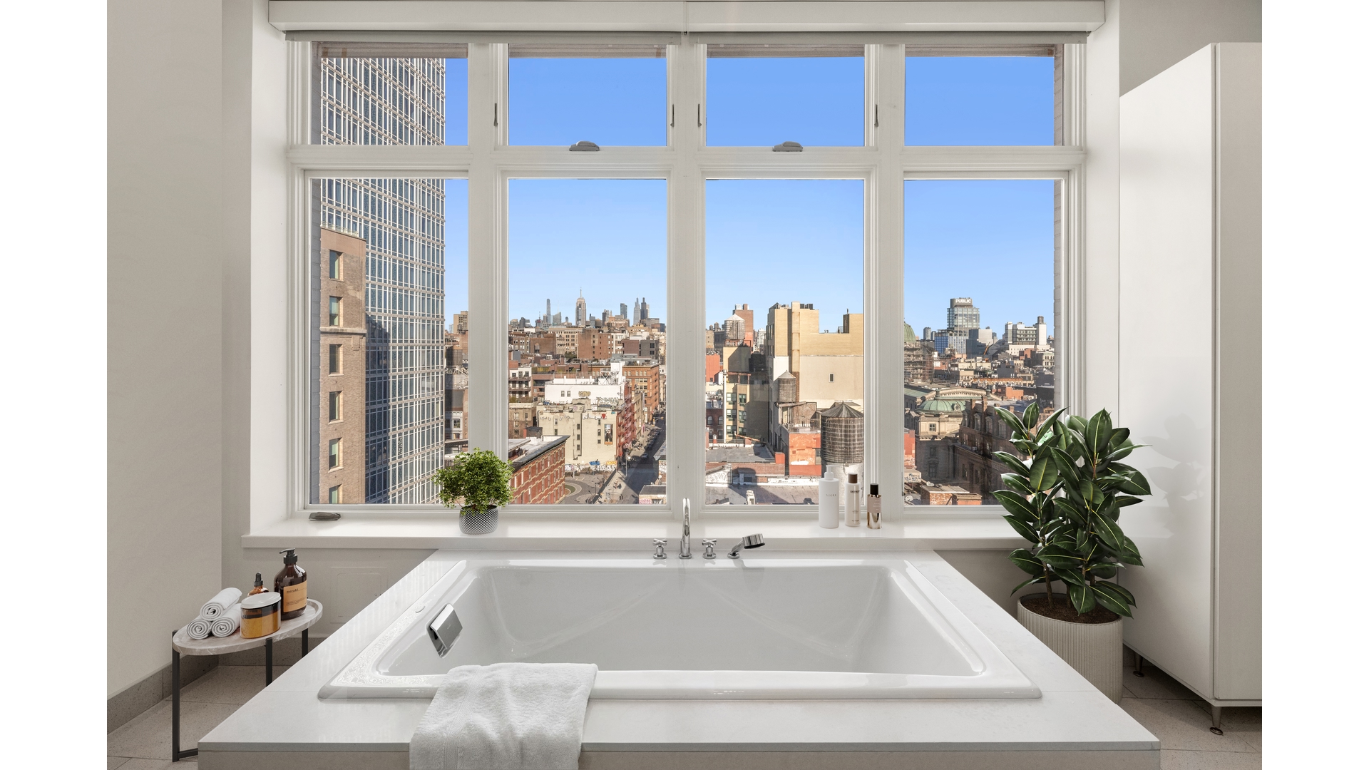 129 Lafayette Street, Unit PHA Manhattan, NY 10013 - Photo 21 of 26 a bathroom with a tub sink and a mirror