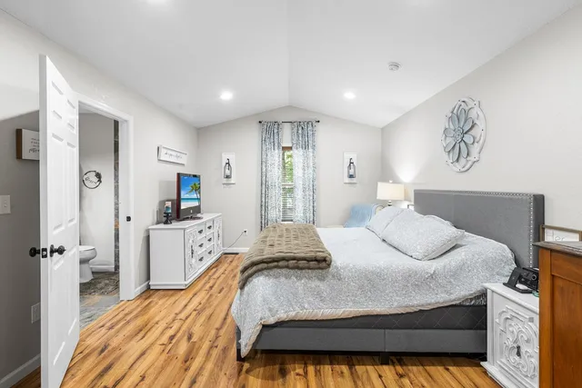 a bedroom with a bed and window