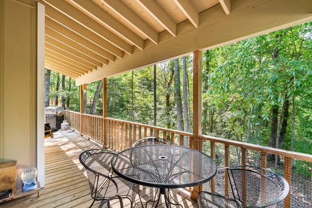a view of balcony with wooden floor and outdoor seating