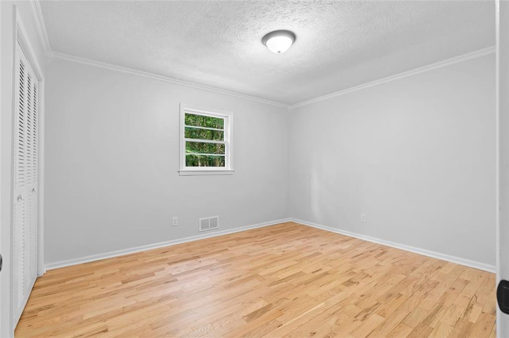 2984 East Paulding Drive Dallas, GA 30157 - Photo 16 of 35 a view of empty room with wooden floor and fan