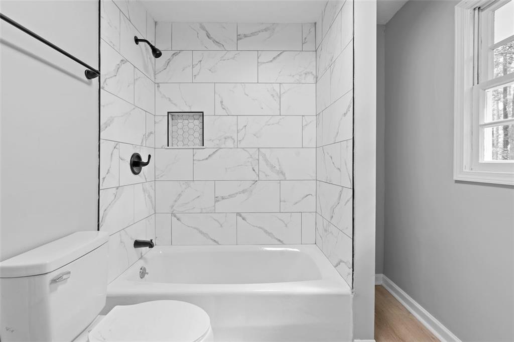 2984 East Paulding Drive Dallas, GA 30157 - Photo 20 of 35 a bathroom with a bathtub and a shower