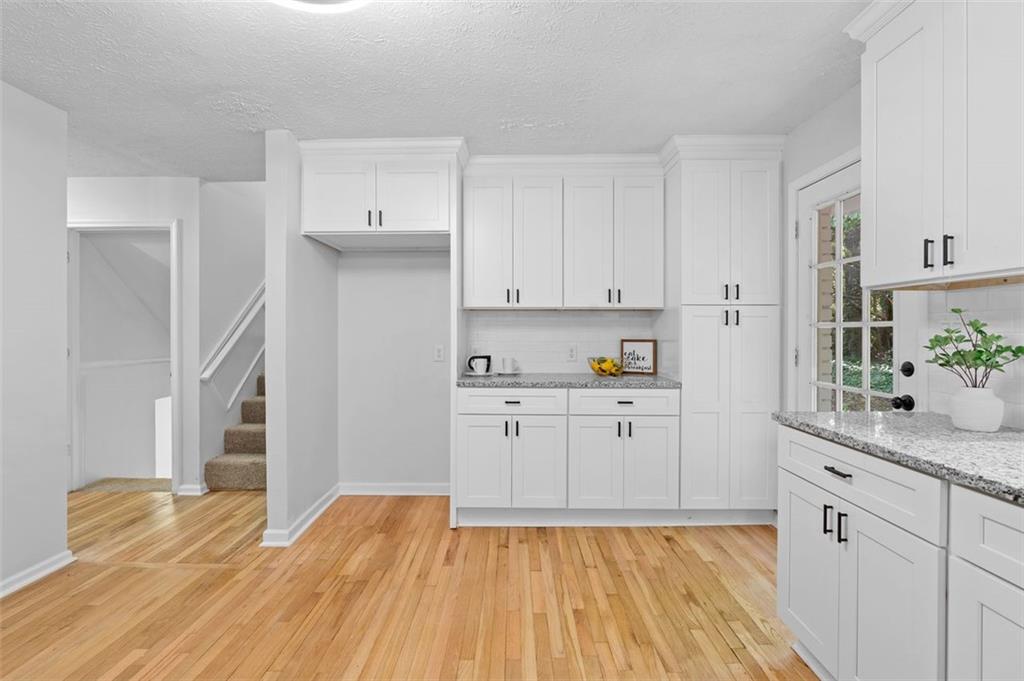 2984 East Paulding Drive Dallas, GA 30157 - Photo 25 of 35 a kitchen with granite countertop white cabinets and white appliances