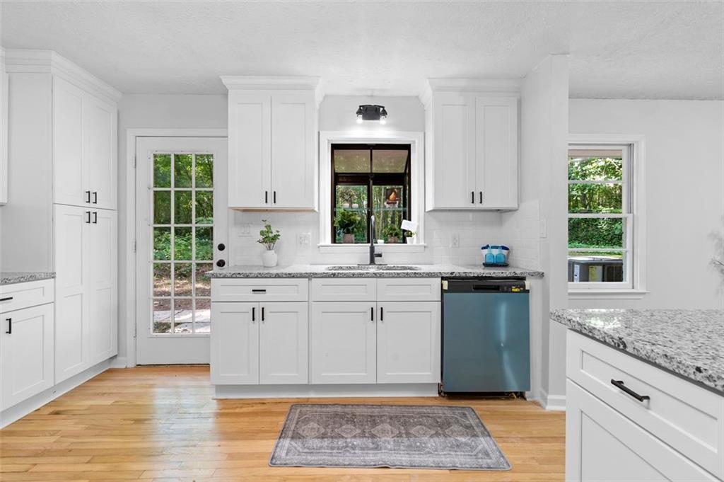 2984 East Paulding Drive Dallas, GA 30157 - Photo 27 of 35 a kitchen with stainless steel appliances granite countertop a stove a sink and a window