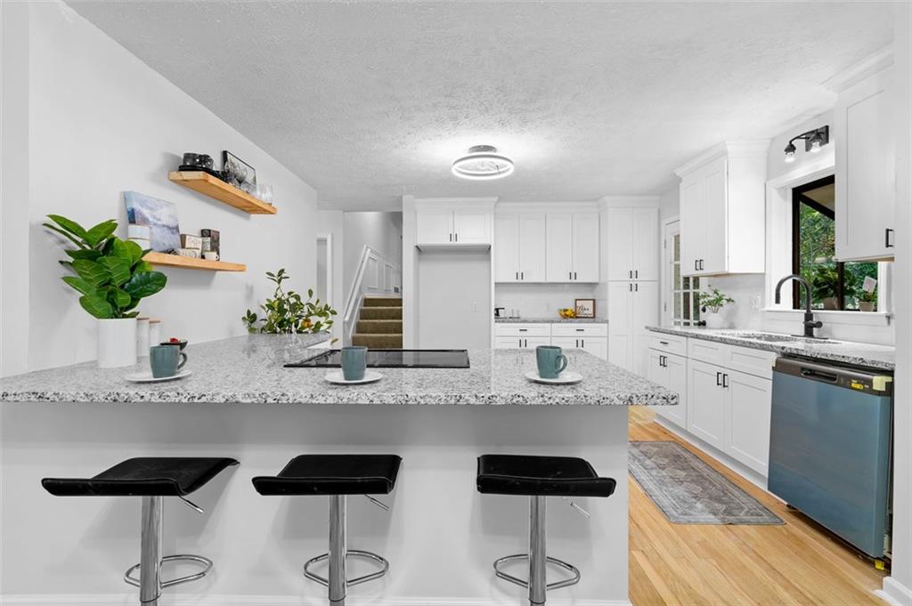 2984 East Paulding Drive Dallas, GA 30157 - Photo 28 of 35 a kitchen with granite countertop white cabinets and stainless steel appliances