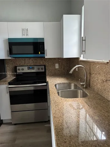a kitchen with a stove and a sink