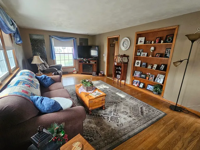 a living room with furniture and wooden floor