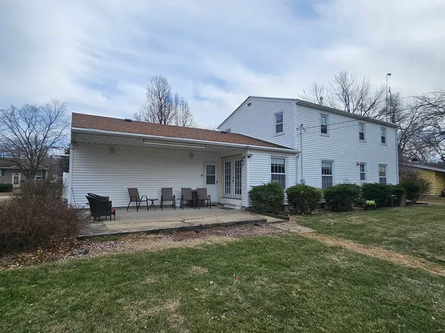 a front view of house with yard and outdoor seating