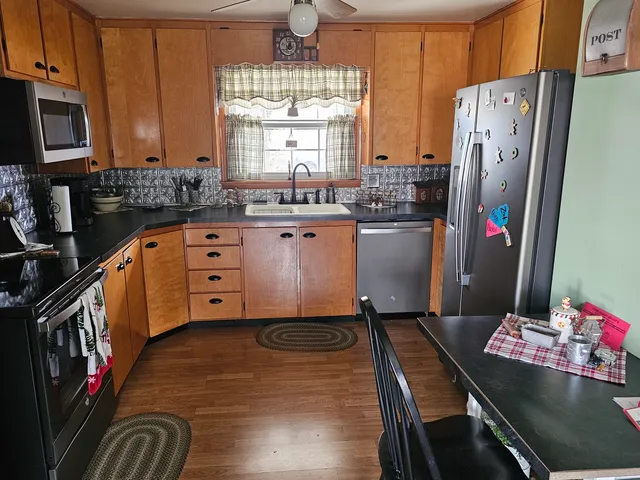 a kitchen with refrigerator and window
