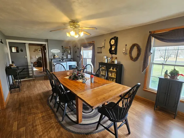 a view of a dining room with furniture and wooden floor