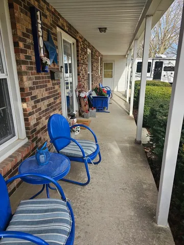 a view of living room with furniture and wooden floor