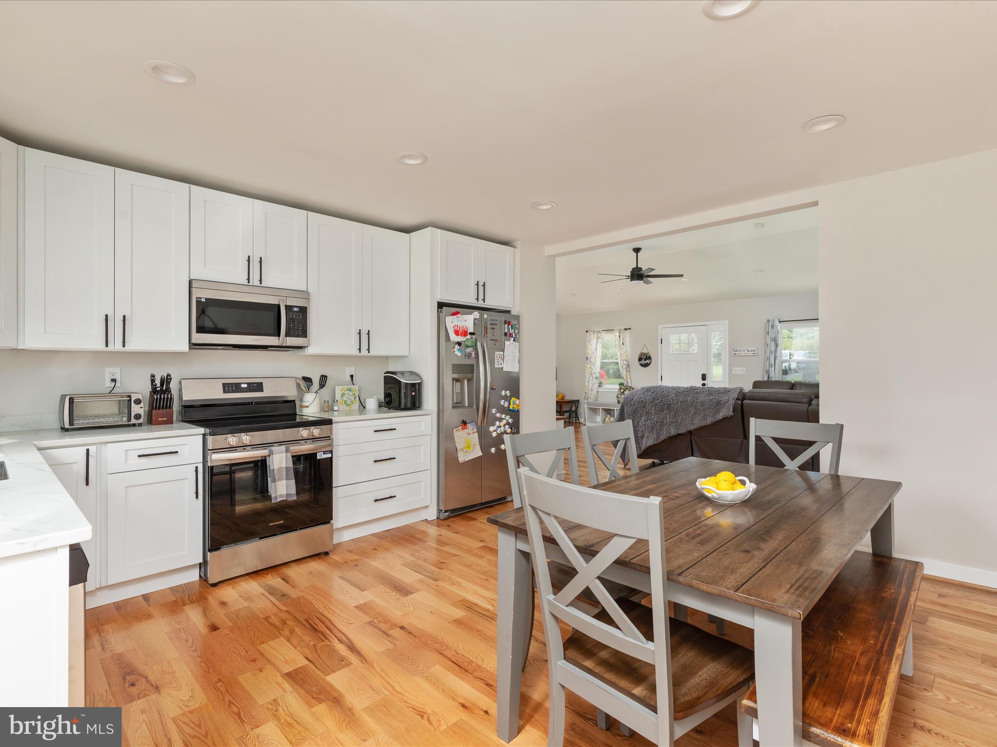790 McDonald Road Winchester, VA 22602 - Photo 2 of 36 a kitchen with stainless steel appliances granite countertop a stove top oven a sink dishwasher and white cabinets with wooden floor