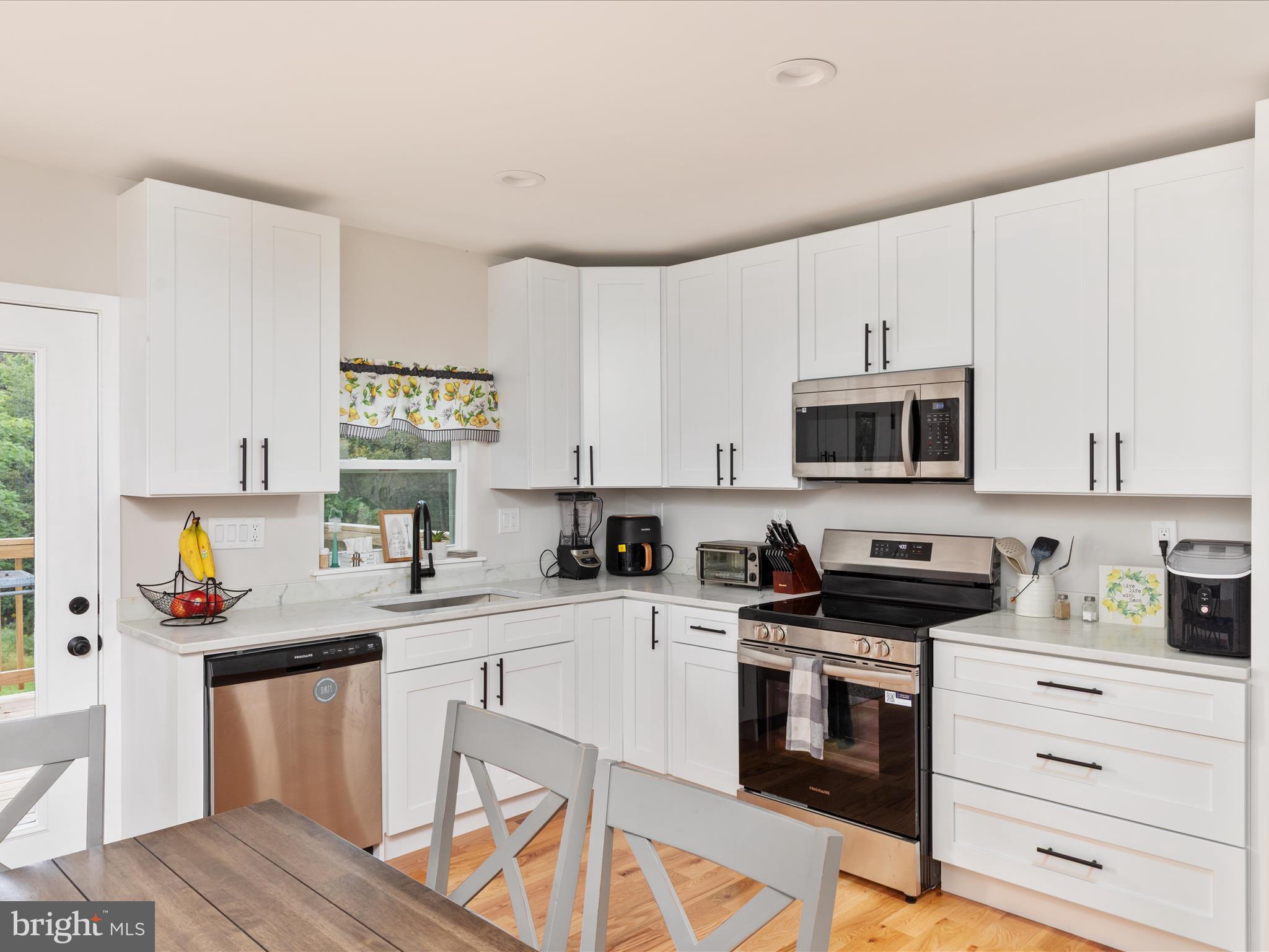 790 McDonald Road Winchester, VA 22602 - Photo 4 of 36 a kitchen with stainless steel appliances a sink stove and white cabinets