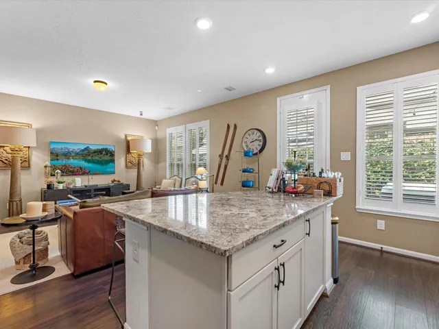 a kitchen with granite countertop a stove and a sink