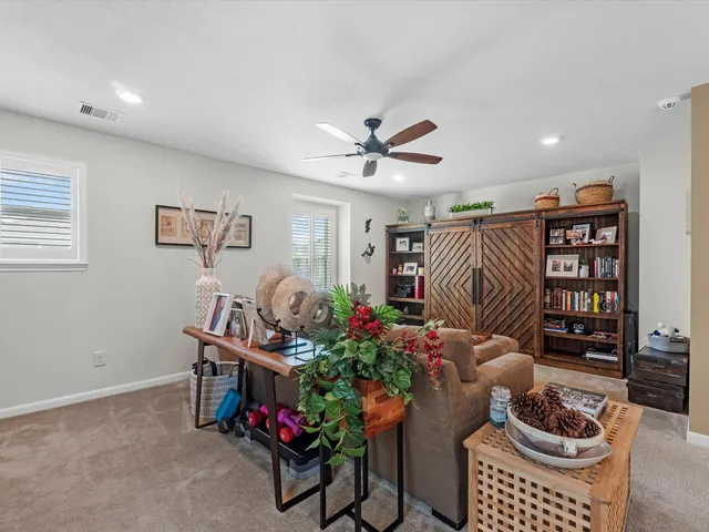 a living room with furniture and flowers