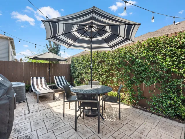 a patio with table and chairs